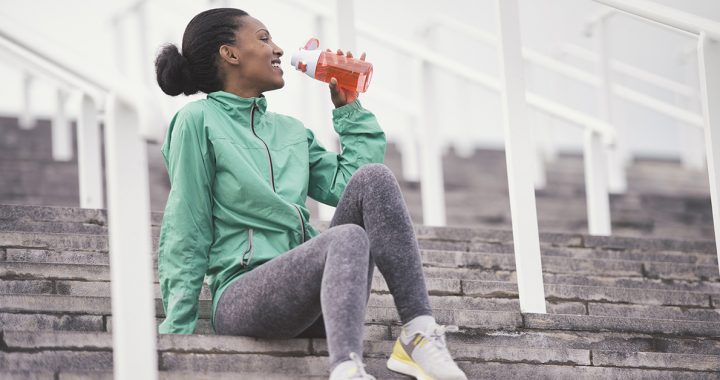 A woman rehydrating after her race.