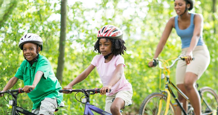african-american family bike riding together - bike safety tips from mercy health