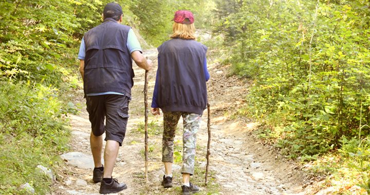 man and woman hike in nature _ benefits of walking
