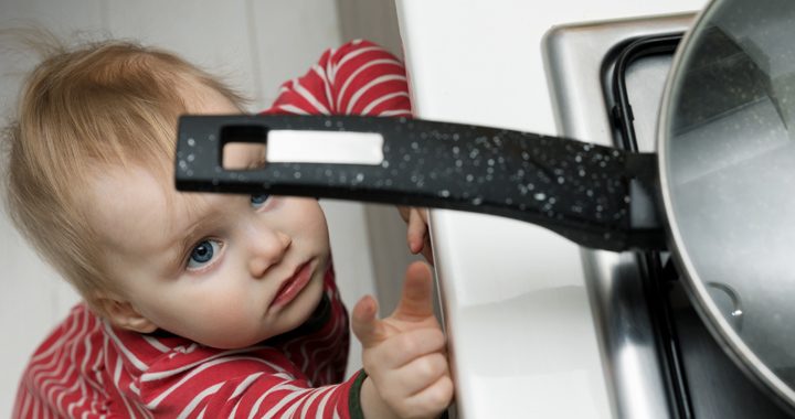 child touches pan on stove _ safety tips for kids at home