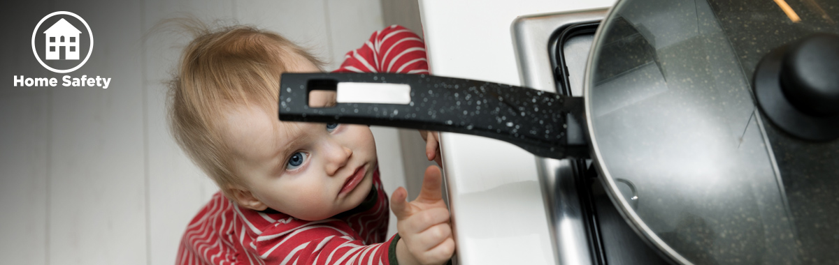 child touches pan on stove _ safety tips for kids at home