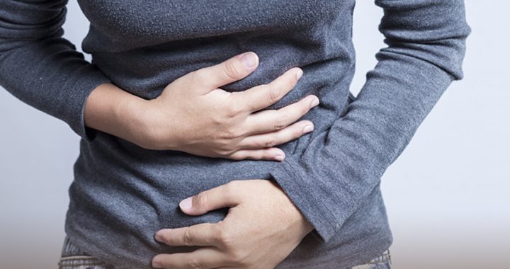 Woman with Crohn's disease holding stomach