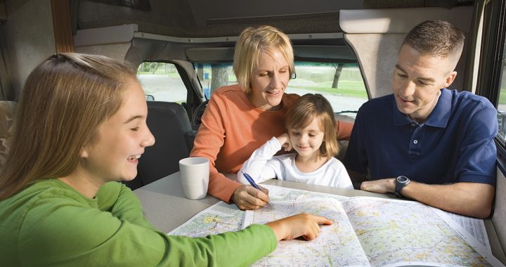 Family of Four looking at a map researching their spring break trip