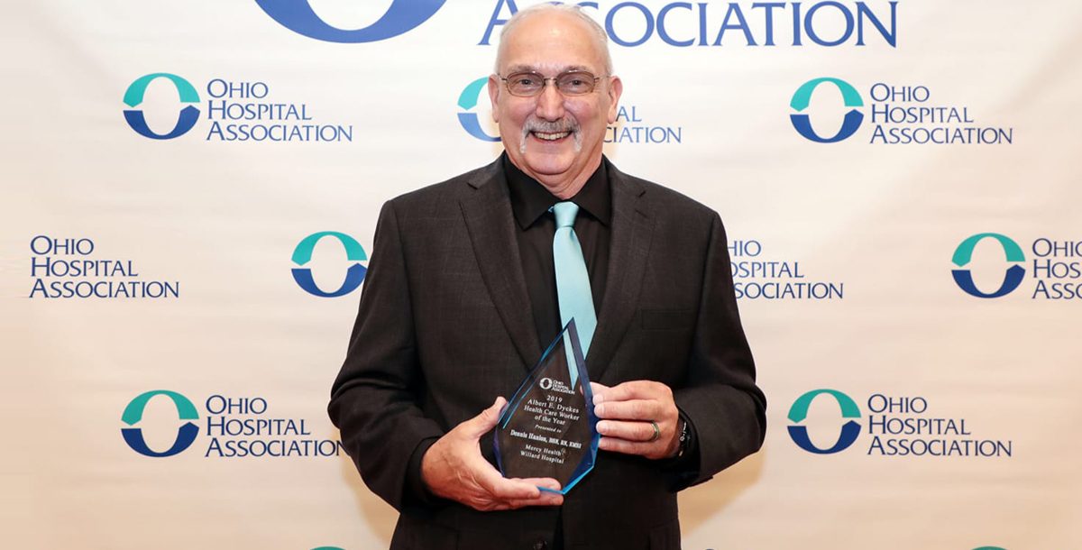 Dennis Hanlon, BSN, RN, EMSI, Paramedic, a shift supervisor in nursing administration at Mercy Health – Willard Hospital, holds his award for being the OHA Health Care Worker of the Year