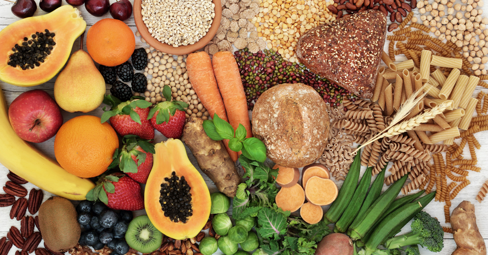 A colorful spread of fruits, vegetables and various grain products contain insoluble and soluble fiber