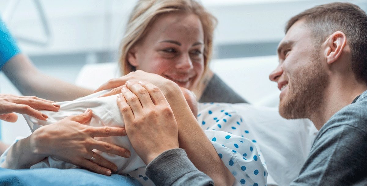 Childbirth moment in a hospital settings with a baby and parents