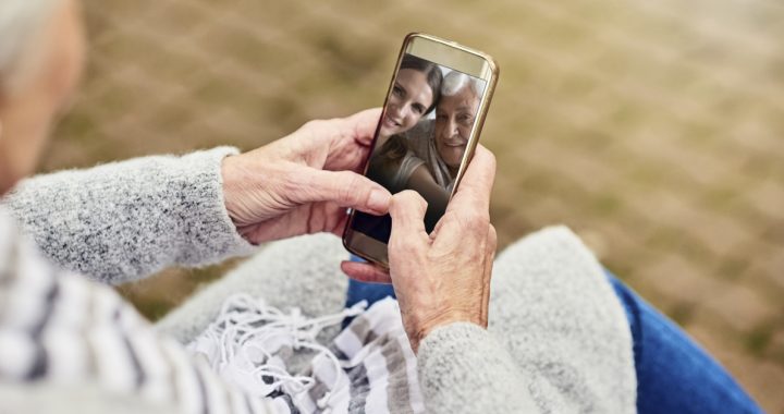 An individual staying in touch with loved ones virtually during COVID-19