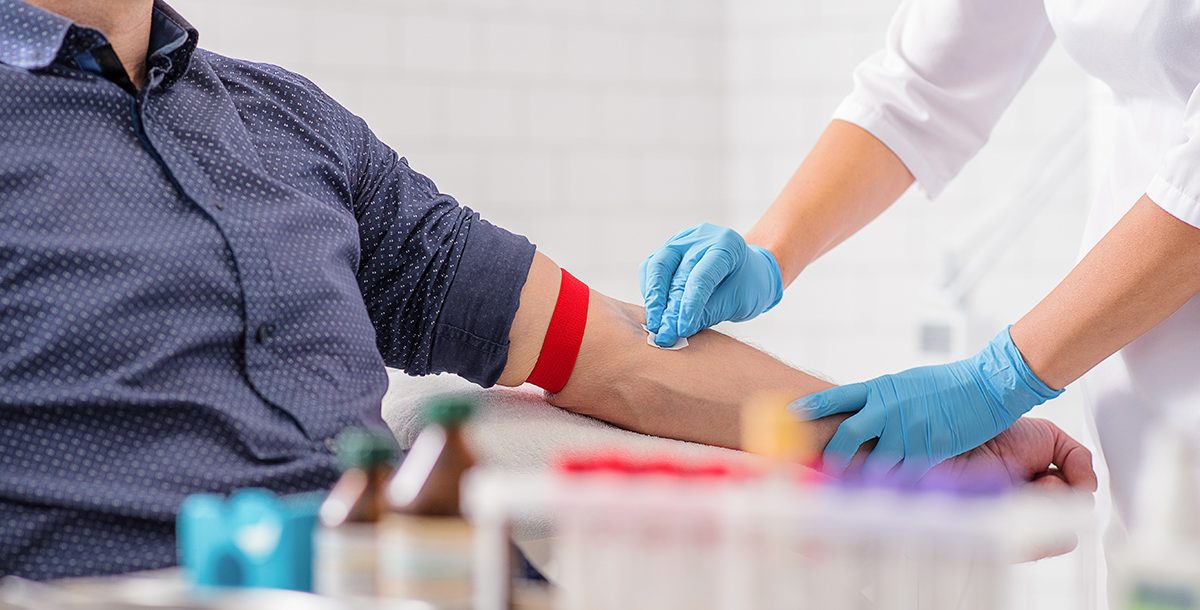 An individual making a blood donation during COVID-19