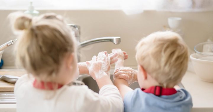 Two children practicing proper handwashing during COVID-19.