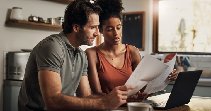 A couple creating a COVID-19 household plan in their kitchen.