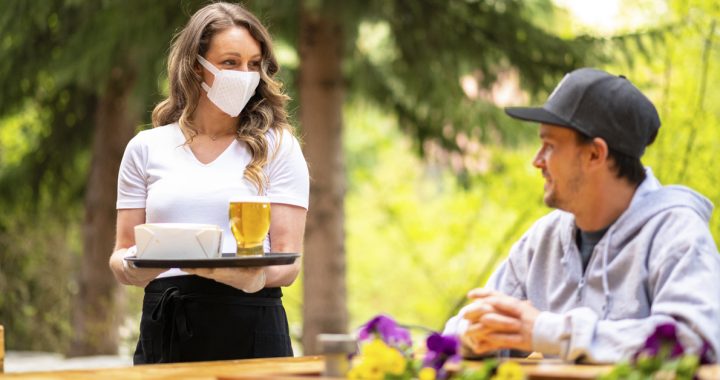 A man dining outside at a restaurant during COVID-19