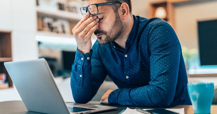 A man experiencing symptoms of burnout.