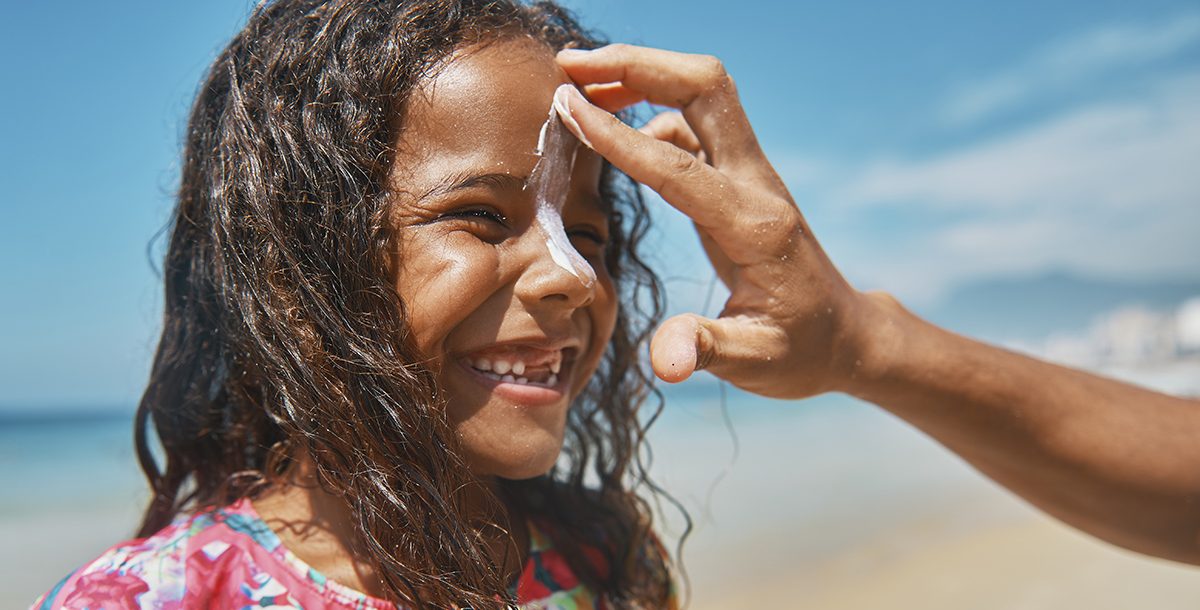 A child putting sunscreen on.