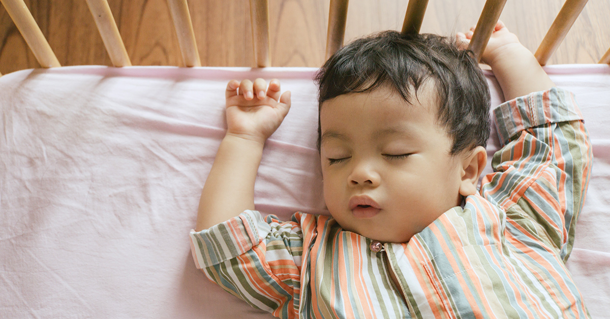 A baby sleeping in a crib.