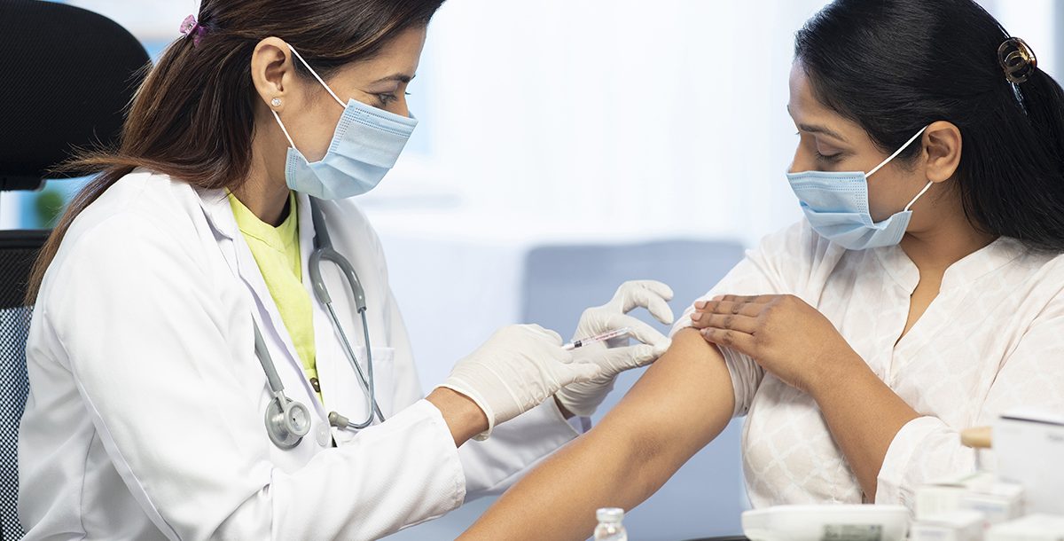 An Immunocompromised woman getting a COVID1-9 vaccine booster shot.