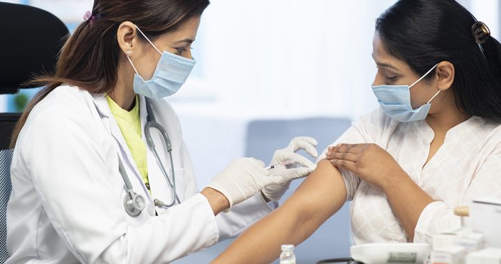 An Immunocompromised woman getting a COVID1-9 vaccine booster shot.