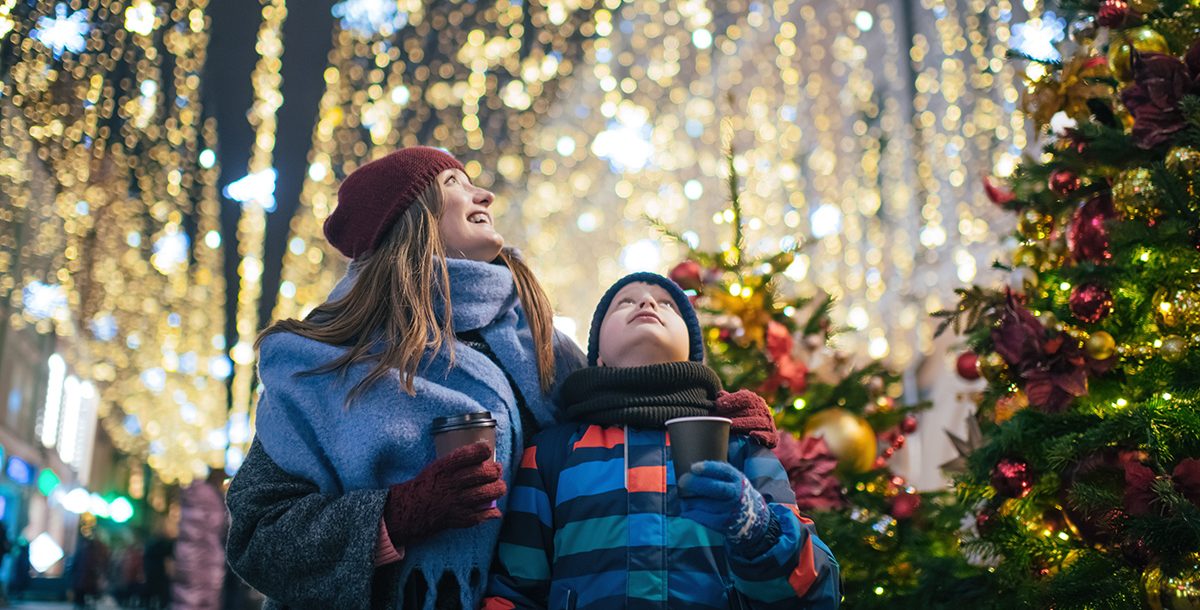 A mother and son looking at holiday lights.