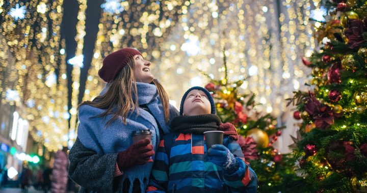 A mother and son looking at holiday lights.
