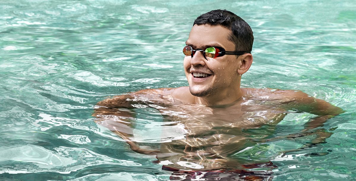 A person wearing goggles in the pool.
