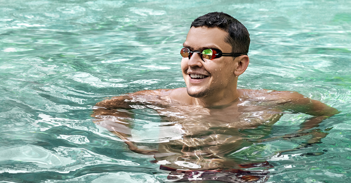 A person wearing goggles in the pool.