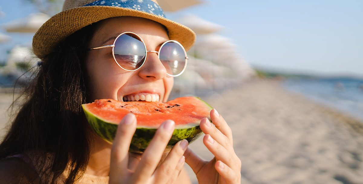 a woman eating watermelon